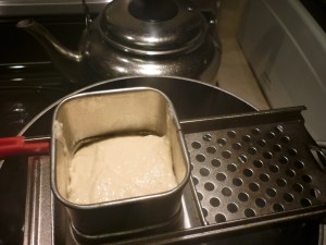 Working in batches, press a batch of batter through the device (spaetzle maker or flat cheese grater or dripping it off a spoon) into the boiling waterThe batter is supposed to drip into the pot and cook in the water. 