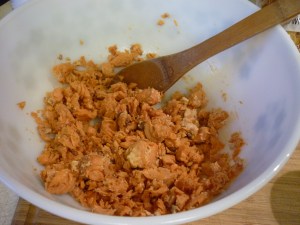 Drain a pint of canned salmon and crumble into a large bowl.