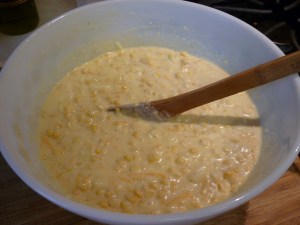 Stir in 2/3 cup milk, 3 tablespoons melted butter, 1 beaten egg, 1 tablespoon sugar, 1/2 cup shredded cheddar, and salt and pepper. 