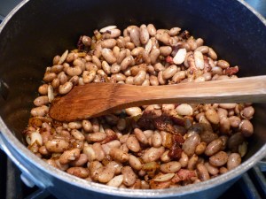 Stir in 1 Tbsp. chili powder. Add beans, 1-3/4 cups water, and pepper to taste.
