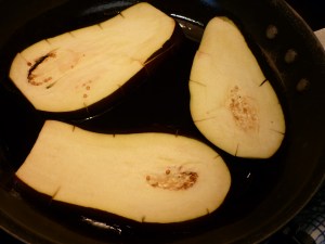 Pat eggplant slices with paper towel to remove moisture and fry slices in olive oil until mostly cooked through.