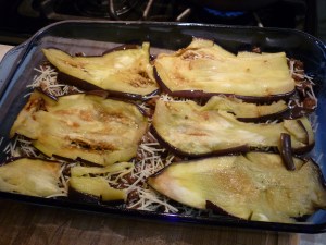 Make a bechamel sauce by melting 1/2 cup butter in a large saucepan over medium heat and stirring in 6 Tbsp. flour. Continue stirring until flour-butter mixture bubbles for awhile. Stir in 4 cups milk. Keep over medium heat, stirring frequently until it's thick and bubbly. Add salt and white pepper to taste. When ready to assemble, place one layer of eggplant in the bottom of a 9x13" baking dish. Cover the eggplant with all of the meat mixture. Sprinkle meat mixture with 1/2 cup grated or shredded Parmesan cheese. Cover that layer with remaining eggplant slices. Sprinkle with 1/2 cup Parmesan cheese.