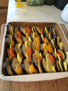 I started with the peppers upright, but when I realized I’d be short at the end, I turned the remaining ones sideways. I filled in some of the gaps with the smaller slices of squash. Sprinkle the top with olive oil, salt, pepper, and sliced fresh basil.