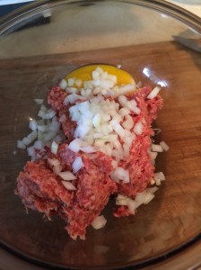 Stir together Italian sausage, egg, onion, mushroom gills, and bread crumbs.