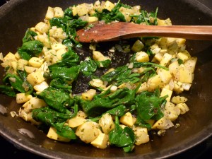 Continue sauteing until spinach has wilted. Remove from heat and let cool for a few minutes.