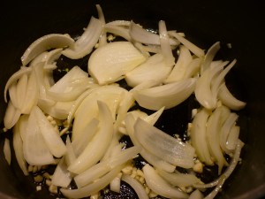 In a large pot or Dutch oven, saute the onion and garlic in olive oil until softened.